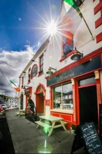 a building with a picnic table outside of a restaurant at Horans Bar and Restaurant in Baltinglass