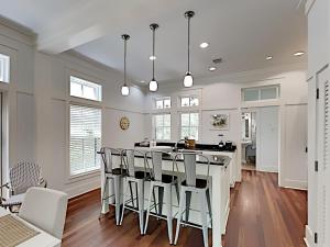 a kitchen and dining room with a table and chairs at Watercolor Whimsea in Seagrove Beach