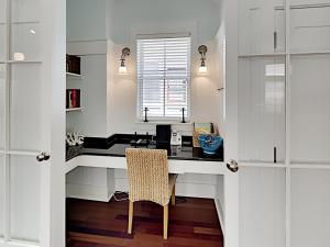 a kitchen with a desk with a chair and a window at Watercolor Whimsea in Seagrove Beach +27 photos