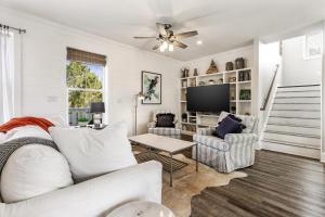 a living room with a couch and a tv at Easy Breezy in Santa Rosa Beach
