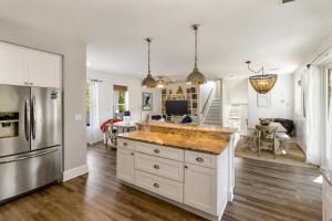 a kitchen with white cabinets and a large counter top at Easy Breezy in Santa Rosa Beach +36 photos