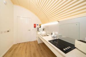 a kitchen with a sink and a counter top at Cultybraggan Hut 38 - Accessible in Comrie