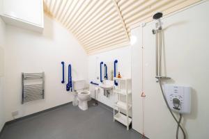 a bathroom with two toilets and a sink at Cultybraggan Hut 38 - Accessible in Comrie