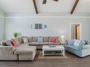 a living room with a couch and two chairs and a table at Sunglow Bungalow in Pensacola Beach