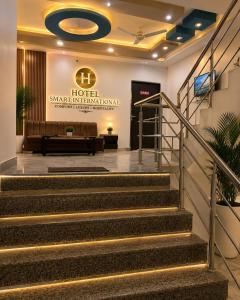 a hotel lobby with stairs and a sign that reads hotel snake international at Hotel Smart International in New Delhi