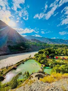 a view of a river with people swimming in it at Fish Lake Park Guest House in Chitral