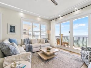 a living room with a couch and a table at Adagio #401B in Santa Rosa Beach