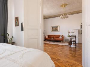a bedroom with a bed and a living room with a couch at City Center Boutique Apartments - Schlossberg View - Free Parking in Graz