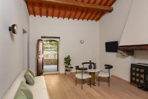 a living room with a couch and a table at Chapter Chianti, a Member of Design Hotels in Cavriglia