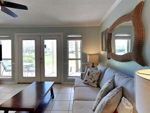 a living room with a couch and a table at Grand Caribbean Perdido Key #114 West in Perdido Key