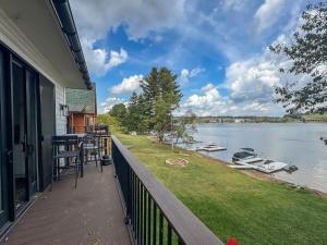 a balcony of a house with a view of a lake at New Luxury Lakefront Walk to Wisp in McHenry