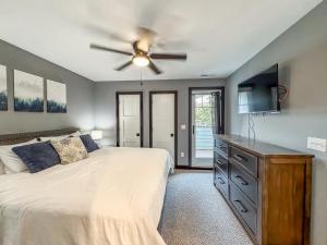 a bedroom with a bed and a ceiling fan at New Luxury Lakefront Walk to Wisp in McHenry