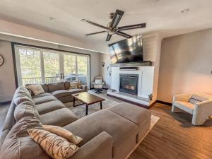 a living room with a couch and a fireplace at New Luxury Lakefront Walk to Wisp in McHenry