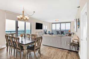 a dining room with a table and a couch at Emerald Dolphin #1610 in Pensacola Beach