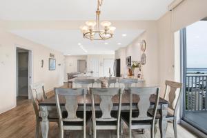 a dining room and living room with a table and chairs at Emerald Dolphin #1610 in Pensacola Beach +20 photos
