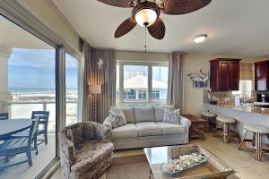 a living room with a couch and a table at Beach Club #206A in Pensacola Beach