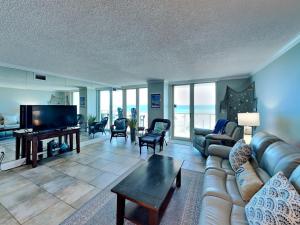 a living room with a couch and a flat screen tv at Sabine Yacht & Racquet #5F in Pensacola Beach