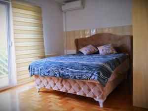 a bed with two pillows on it in a room at Kuća za odmor Đogić - bazen & jacuzzi in Ilidža +16 photos