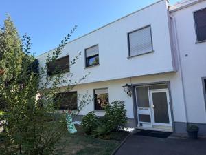 a white building with a door and windows at Village Apartment Rheinbreitbach in Rheinbreitbach