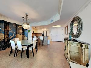 a dining room with a table and chairs and a mirror at Portofino Island Resort #2-1608 in Pensacola Beach