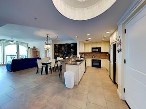 a large kitchen and dining room with a table and chairs at Portofino Island Resort #2-1608 in Pensacola Beach