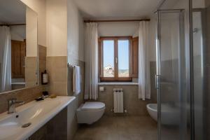 a bathroom with a sink and a toilet and a shower at Relais Cloister Pienza in Pienza +66 photos