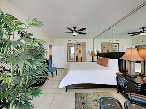 a bedroom with a large bed with a ceiling fan at Emerald Dolphin #1630 in Pensacola Beach +6 photos