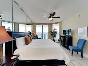 a bedroom with a large bed with a ceiling fan at Emerald Dolphin #1630 in Pensacola Beach