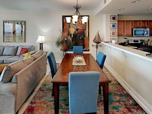 a living room with a table and a couch at Emerald Dolphin #1630 in Pensacola Beach