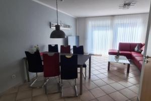 a living room with a table and chairs and a couch at Haus Rüther in Borkum