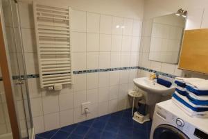 a bathroom with a sink and a washing machine at Haus Rüther in Borkum +9 photos