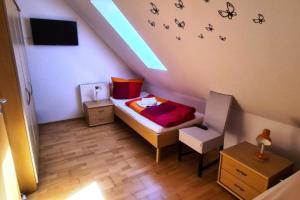 a small bedroom with a bed with butterflies on the wall at Haus Rüther in Borkum