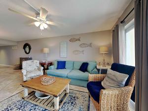 a living room with a blue couch and chairs at Regency Towers #205 West in Pensacola Beach