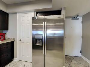 a large stainless steel refrigerator in a kitchen at Regency Towers #205 West in Pensacola Beach +18 photos