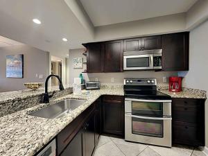 a kitchen with a sink and a microwave at Regency Towers #205 West in Pensacola Beach