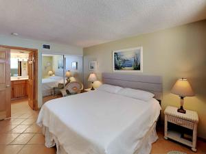 a bedroom with a large white bed in a room at Santa Rosa Dunes #952 in Pensacola Beach +14 photos
