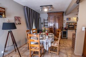 a dining room with a table and chairs at La villa d'alyxia in La Bastide-Puylaurent +8 photos