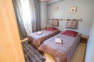 a bedroom with two beds and a window at La villa d'alyxia in La Bastide-Puylaurent
