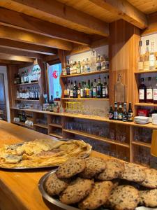 a counter with some bread and some food on it at Le Grand Tetras in Saint-Véran +29 photos
