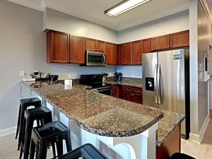 a kitchen with a counter and a refrigerator at Village Of South Walton #263A in Rosemary Beach