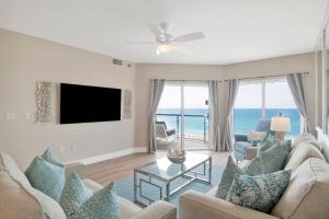 a living room with a view of the ocean at Emerald Isle #602 in Pensacola Beach