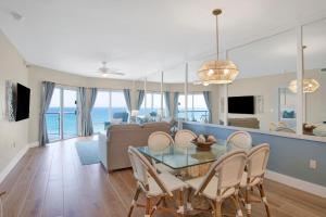 a dining room and living room with a view of the ocean at Emerald Isle #602 in Pensacola Beach +22 photos