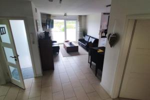 a room with a living room with a couch and a table at Strandriff in Borkum