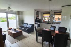 a kitchen and living room with a table and chairs at Strandriff in Borkum