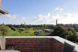 a brick wall with a view of a city at Strandriff in Borkum