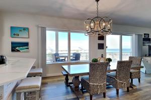 a kitchen and dining room with a table and chairs at Crystal View #303 in Destin