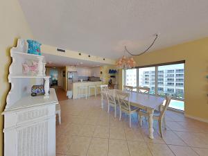 a dining room and kitchen with a table and chairs at Emerald Isle #401 in Pensacola Beach