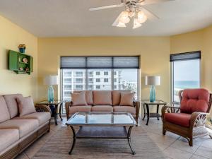 a living room with a couch and chairs and a table at Emerald Isle #401 in Pensacola Beach