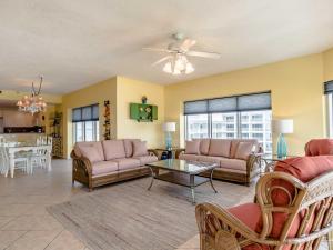 a living room with couches and a table at Emerald Isle #401 in Pensacola Beach