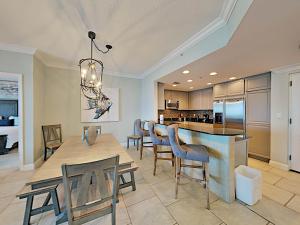 a dining room and kitchen with a table and chairs at Portofino Island Resort #1-702 in Pensacola Beach